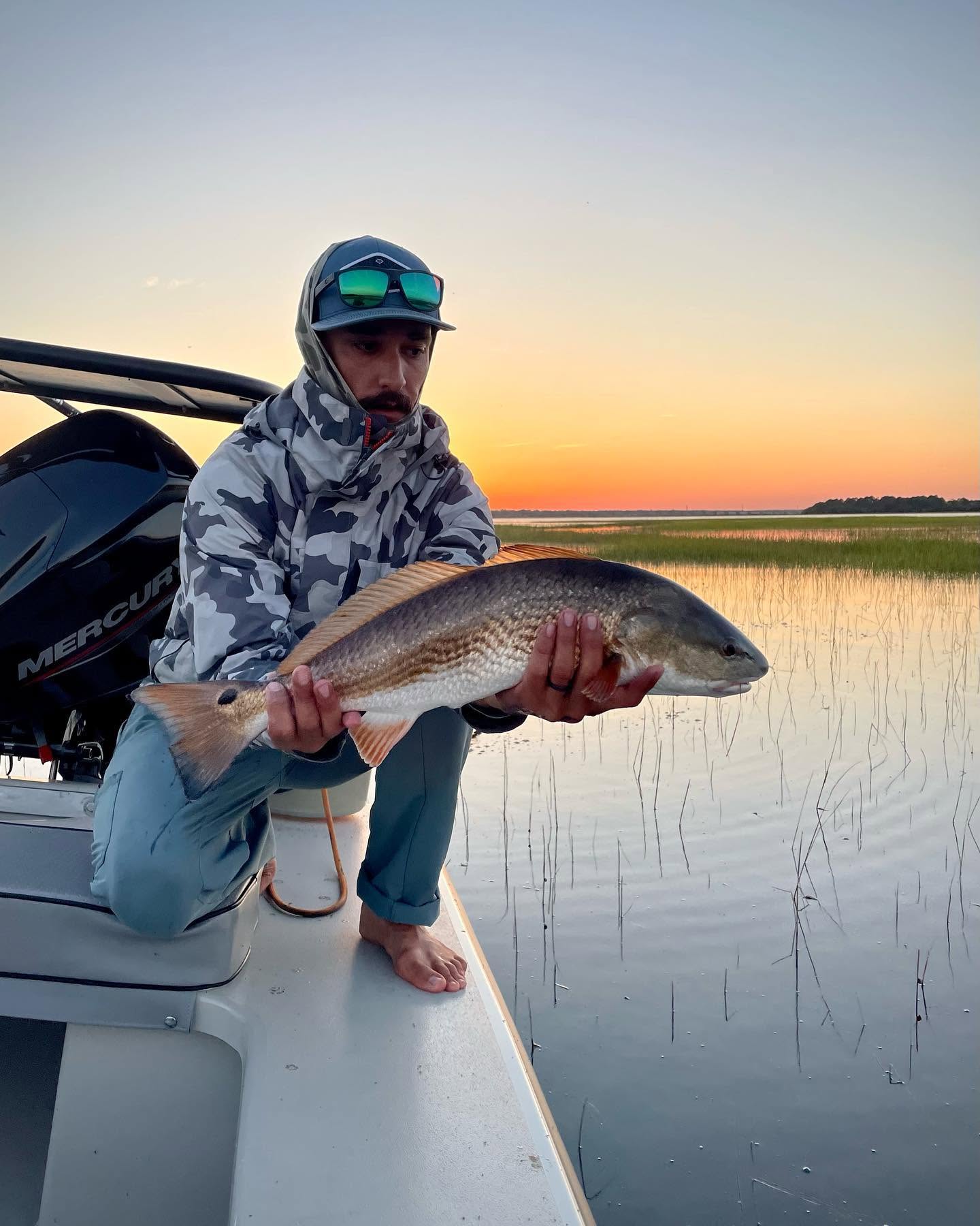 Redfish catch on fishing boat in Johns Island SC marshes at sunset