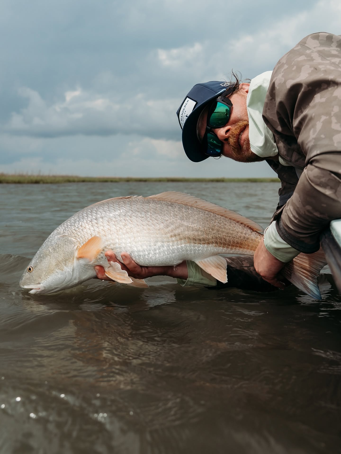 Redfish being held in shallow water during fishing trip in Johns Island SC