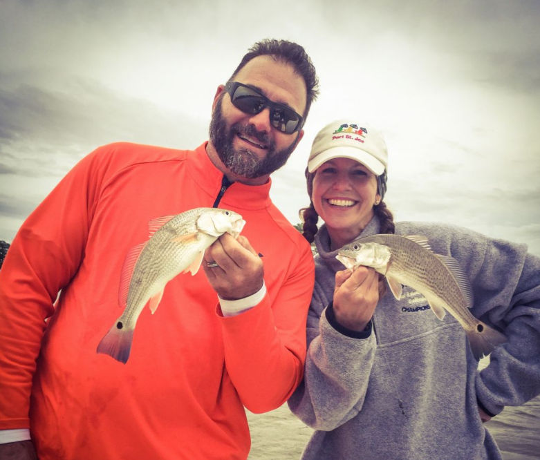 Two anglers fishing with their catch in Port St Joe