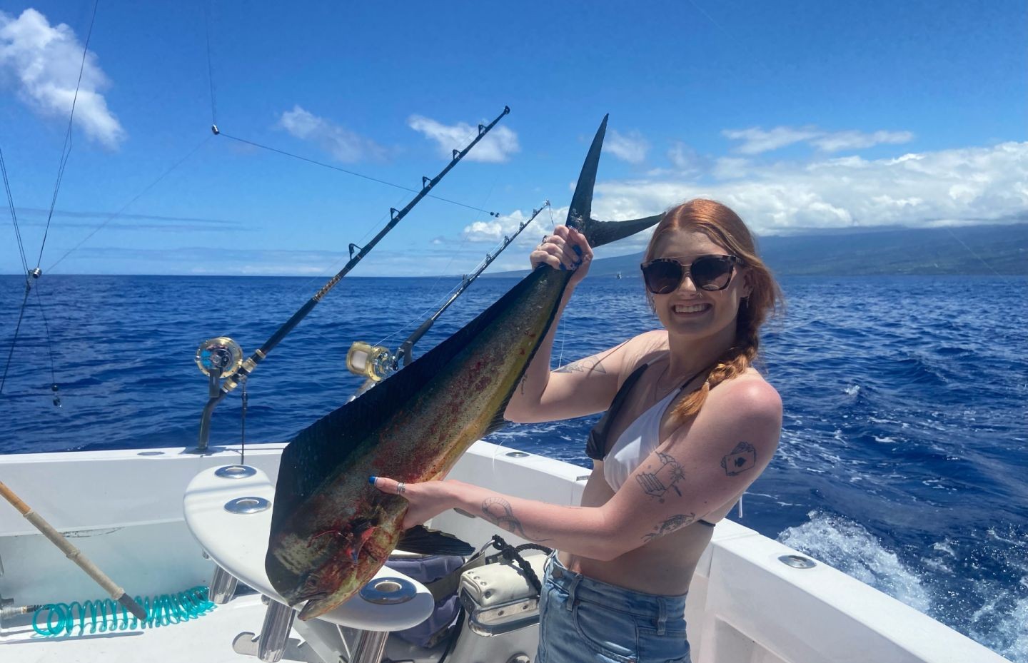 Kona Hawaii offshore fishing charter boat with guests catching marlin and tuna on 6-hour trip