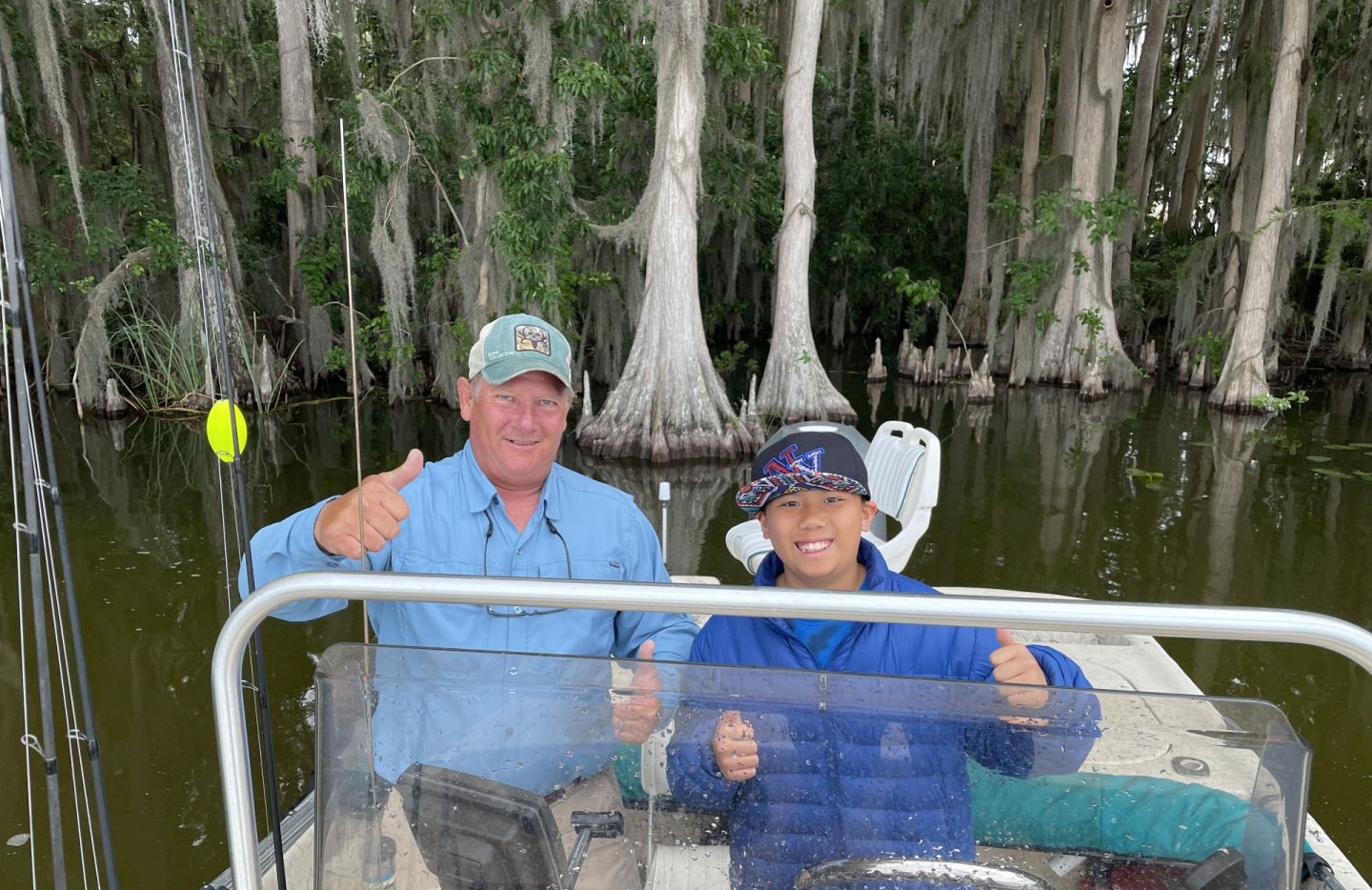 Fishing boat on swamp waters surrounded by cypress trees in Grand Island FL