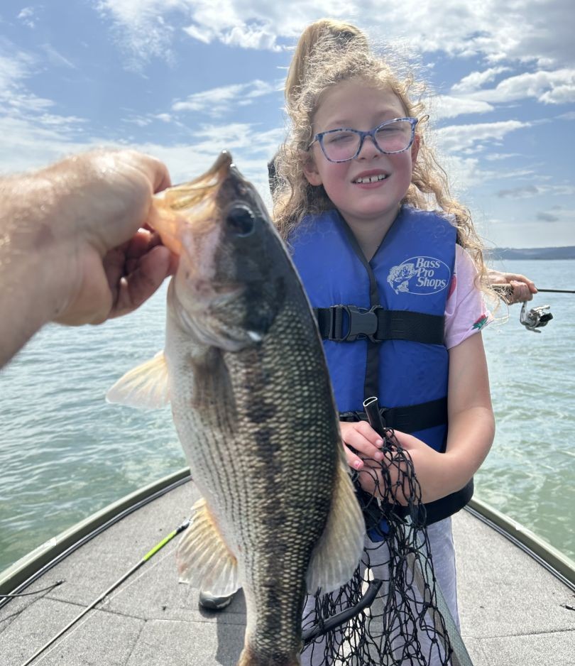 Spotted bass caught while fishing in Branson MO held up on boat