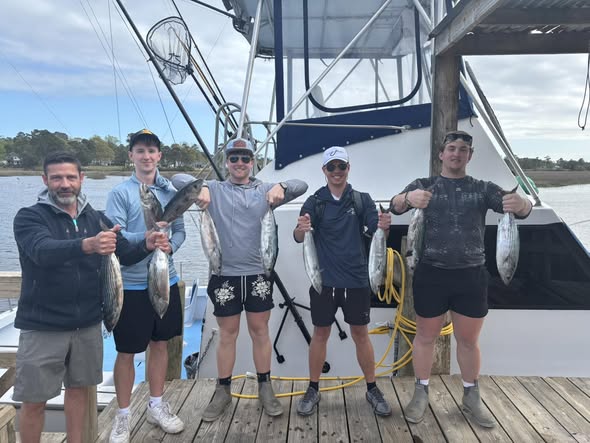 Fishing group displaying catch of mixed species on boat dock in Calabash NC