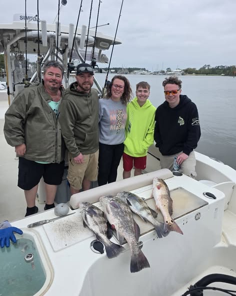 Successful fishing trip in Gulf Shores AL with redfish catch displayed on boat deck