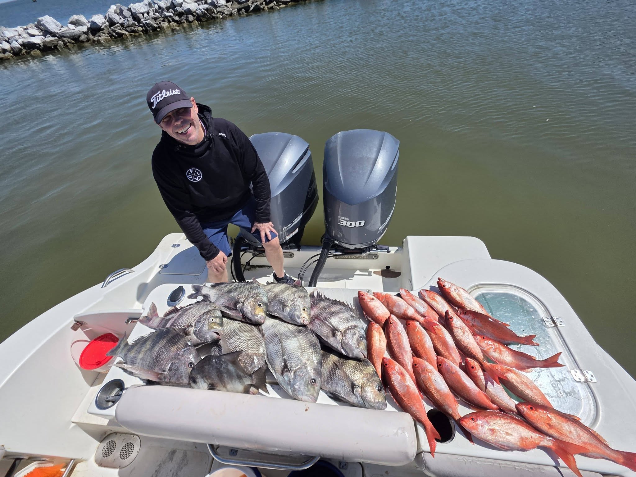 Successful fishing trip displaying sheepshead and spadefish catch on boat deck in Gulf Shores Alabama
