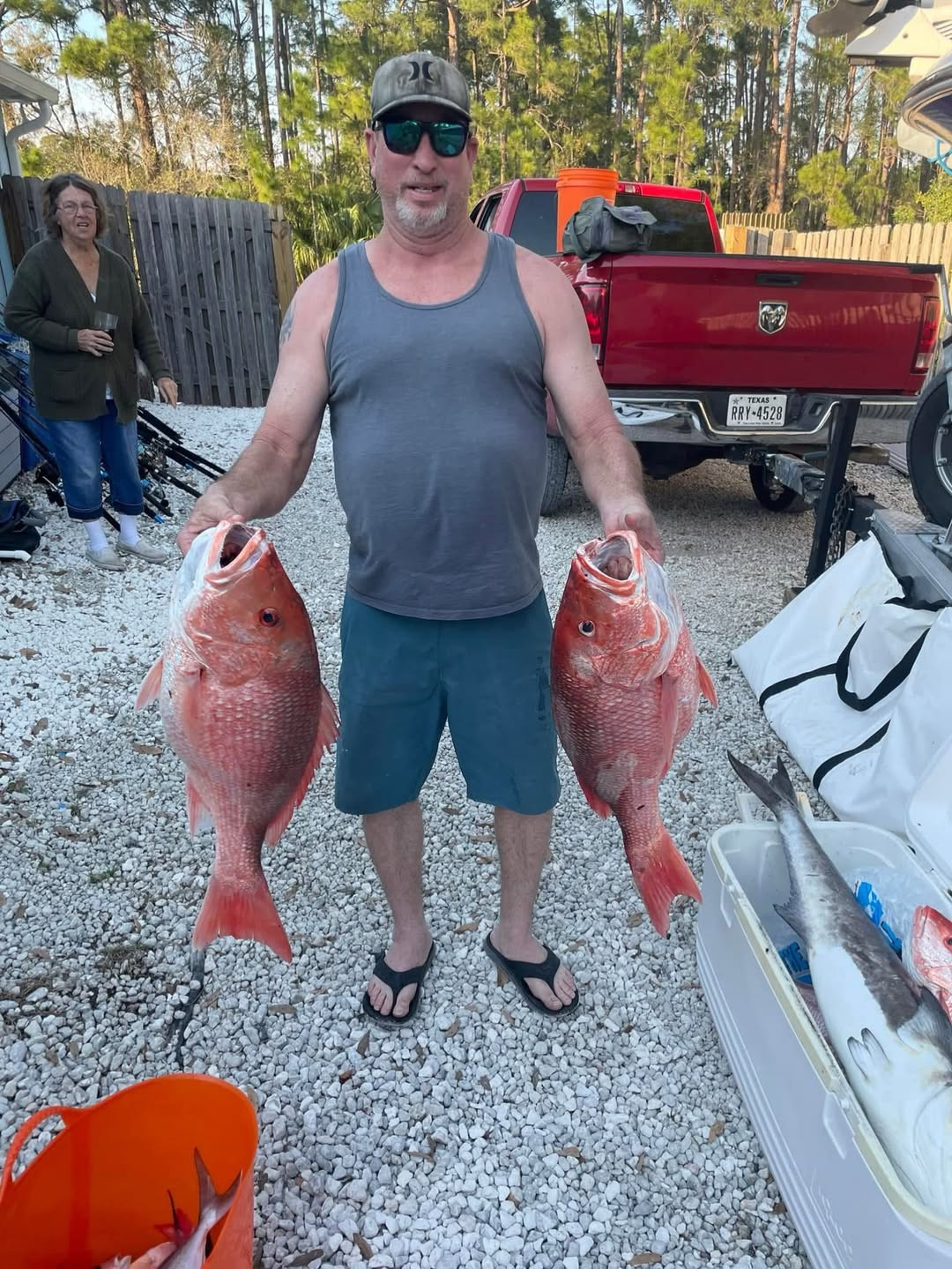 Two red snapper caught fishing in Grant-Valkaria Florida displayed on gravel driveway