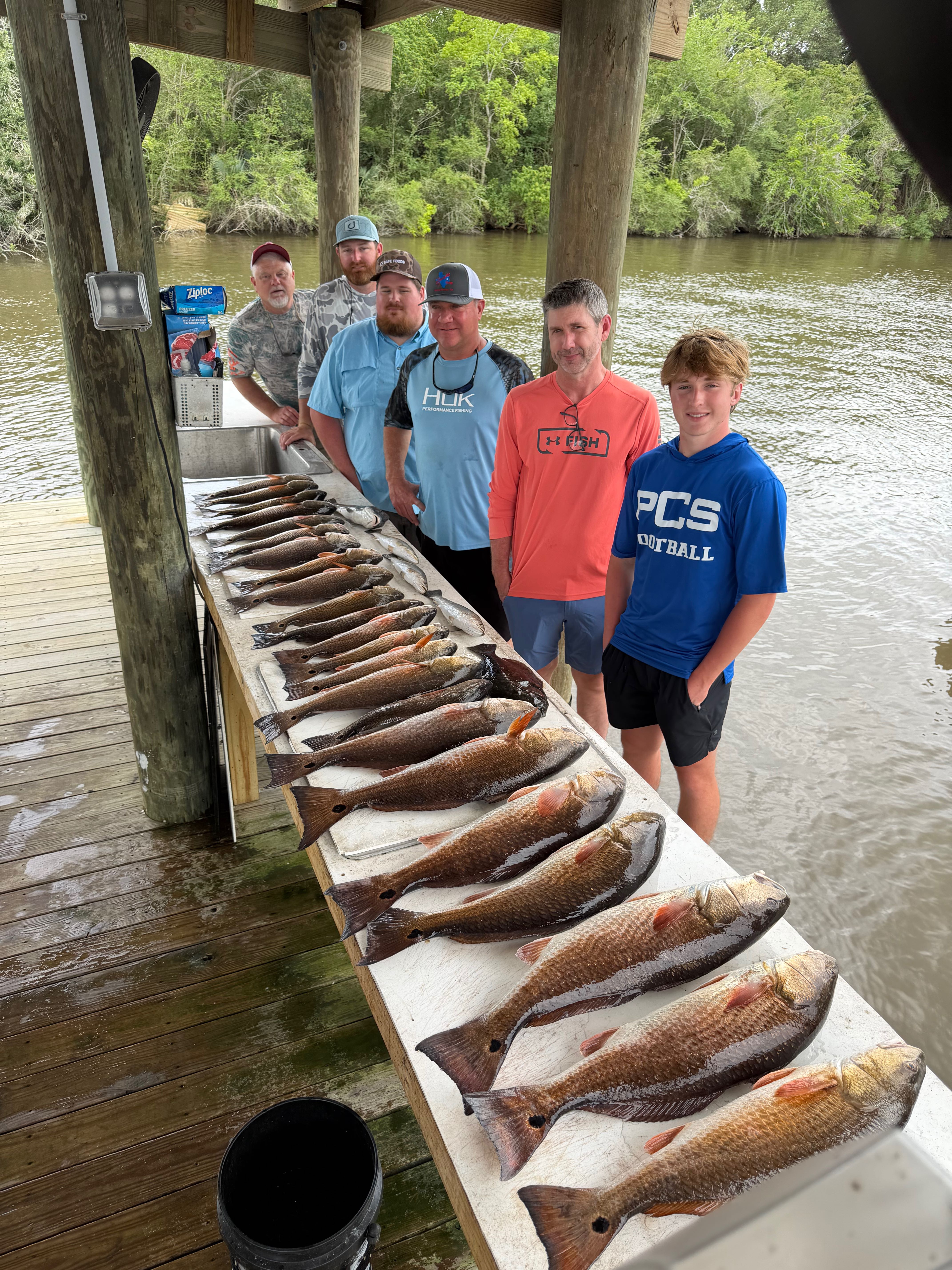 Successful redfish fishing trip display on cleaning station dock in Hopedale Louisiana
