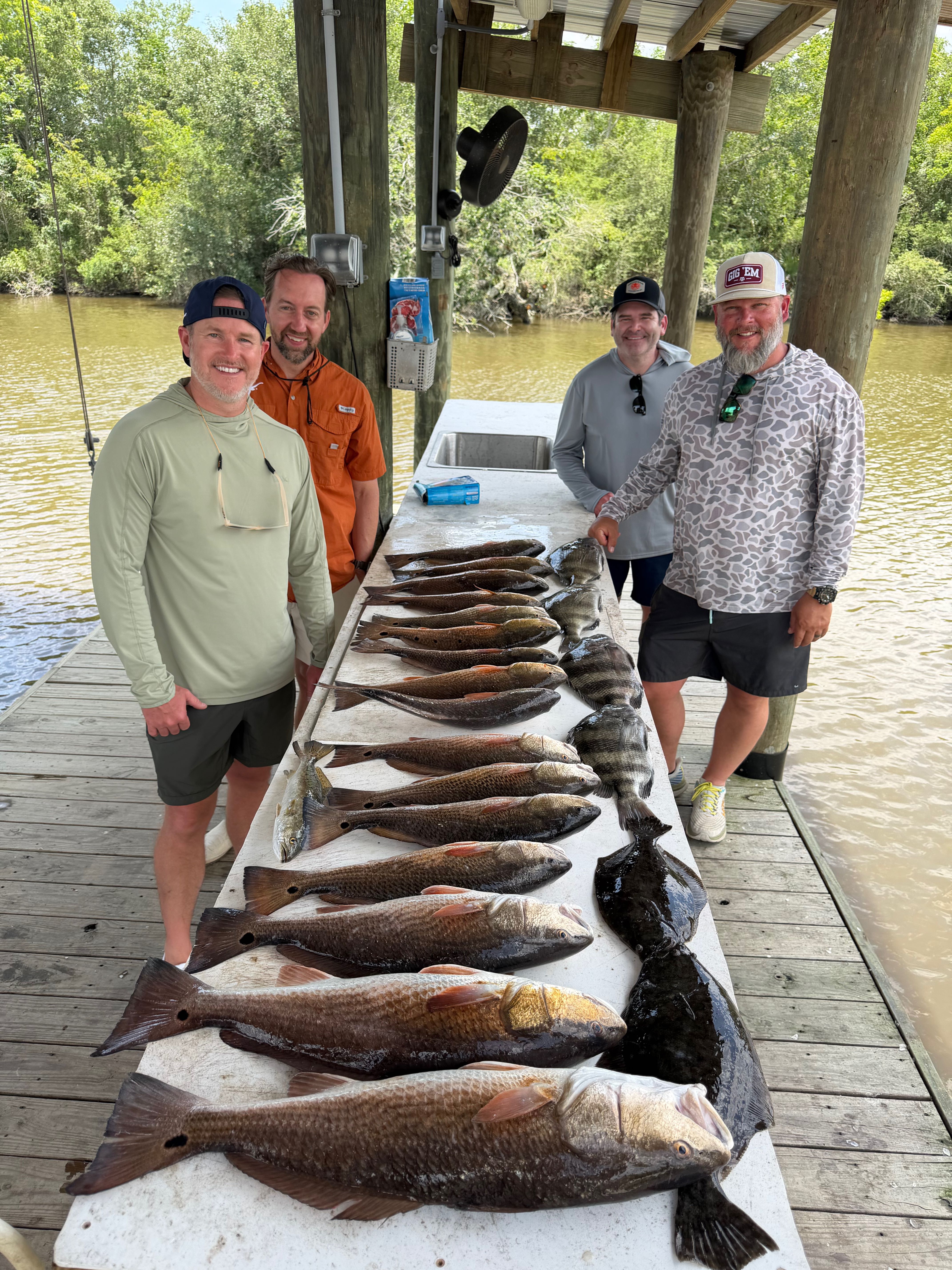 Successful redfish fishing trip displaying catch on cleaning table at dock in Hopedale Louisiana