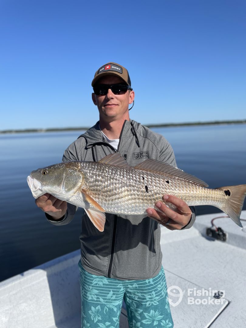 Fisherman holding a large redfish in Alabama