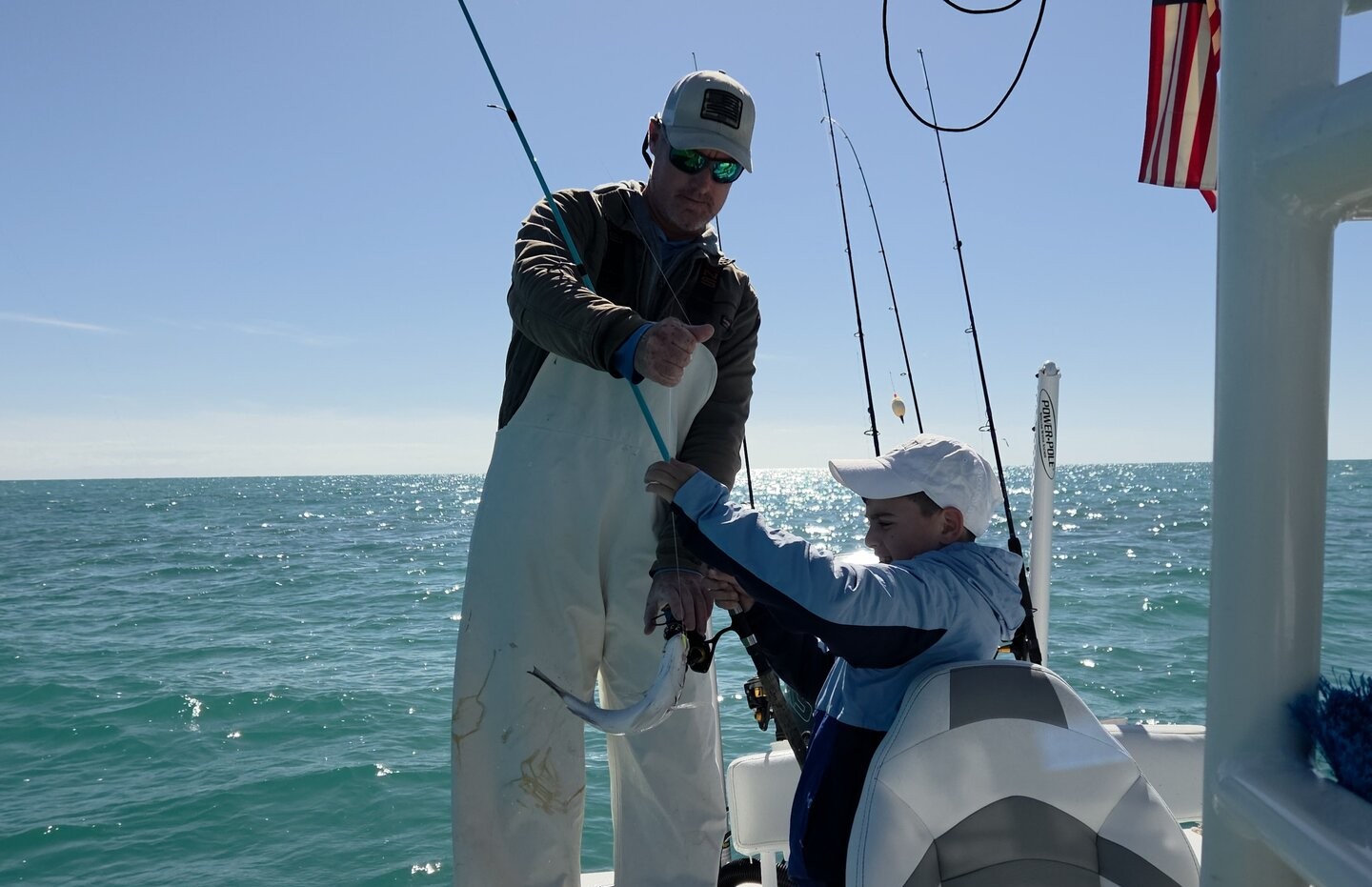 Fishing action on boat in Key Largo FL waters with fishing rods and equipment