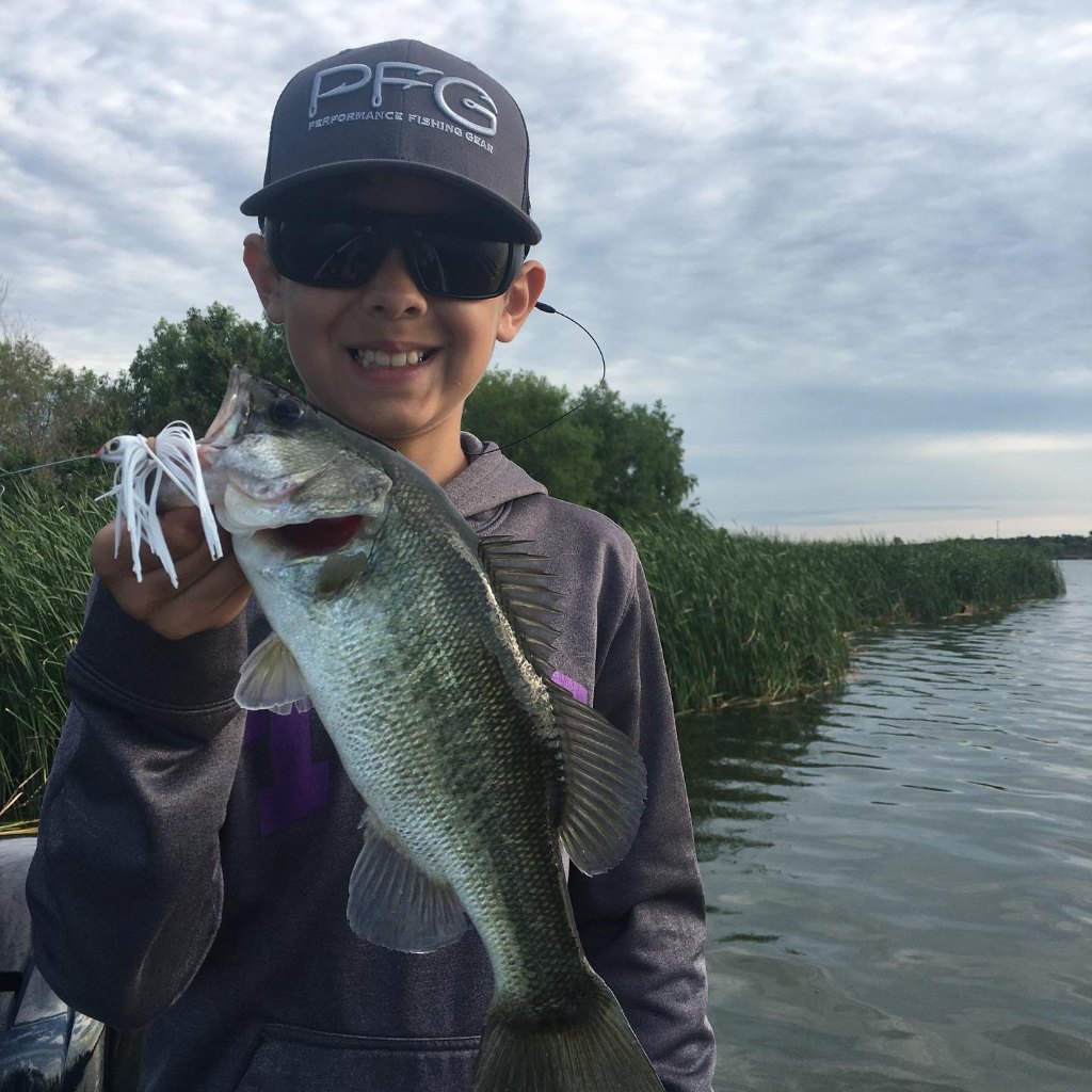 Angler holding a large Florida Bass fish in Leander