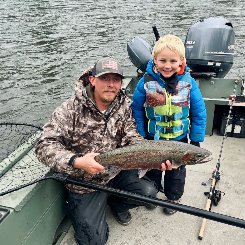 A fisherman holding a rainbow trout fish in Chehalis