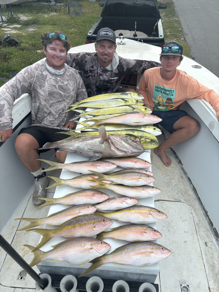 Fishing charter displaying catch of yellowfin tuna, mahi mahi, and red grouper on boat deck in Summerland Key Florida