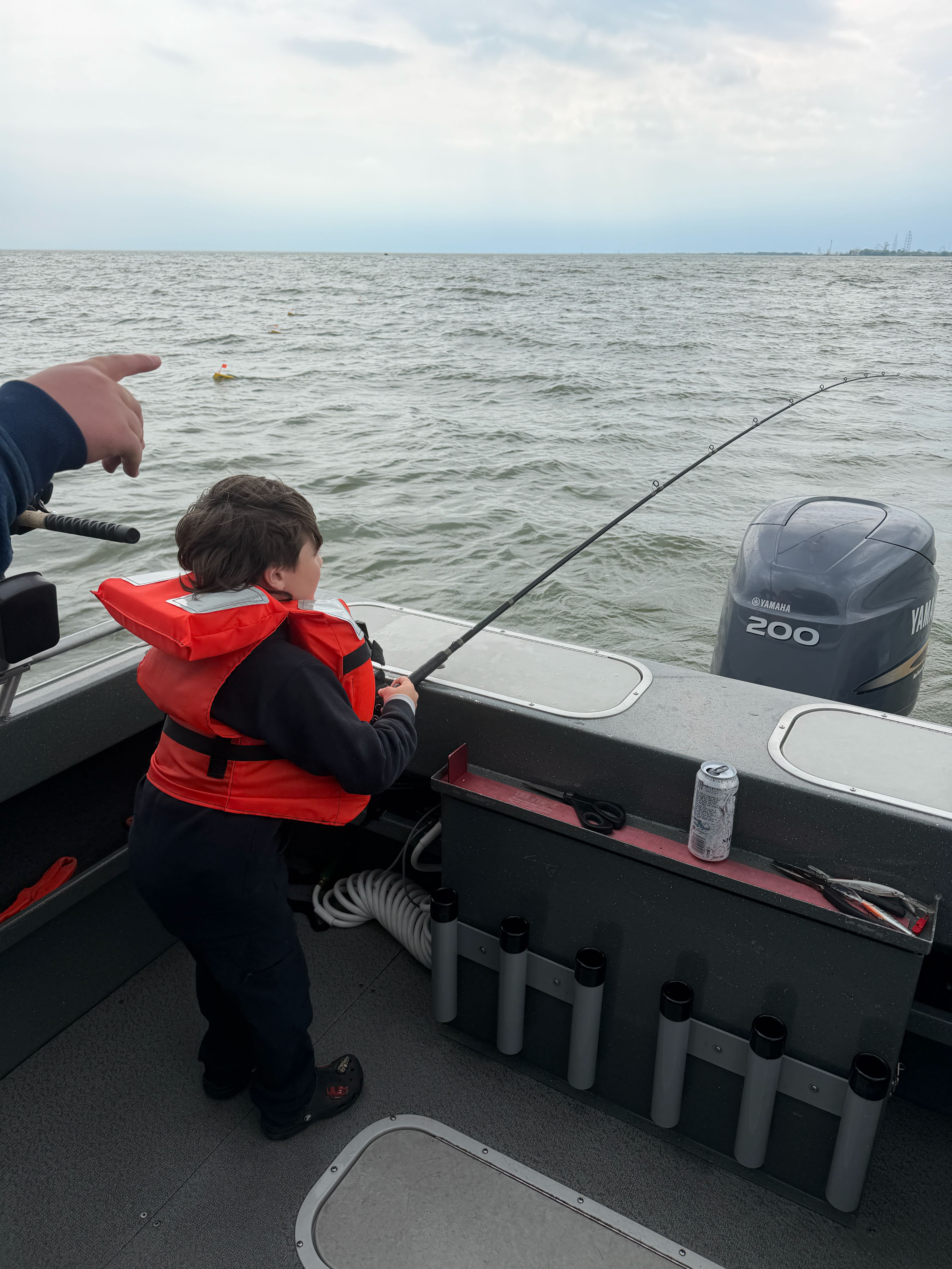 Fishing boat on open water with rod holder and outboard motor in Spencerville OH