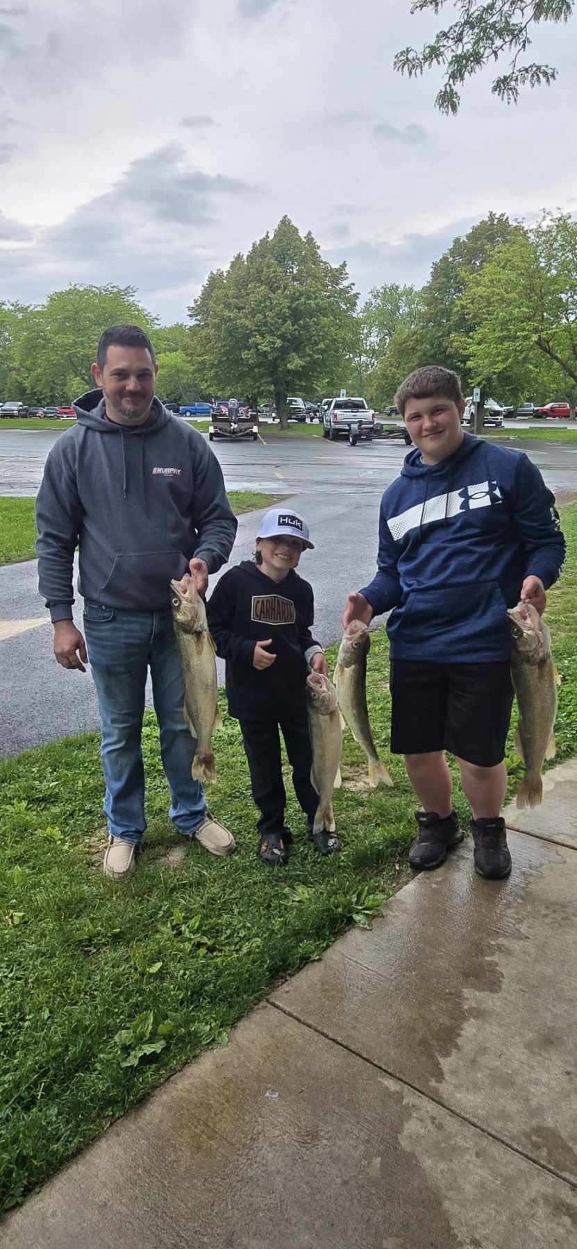 Three freshly caught walleye displayed after successful fishing trip in Spencerville OH