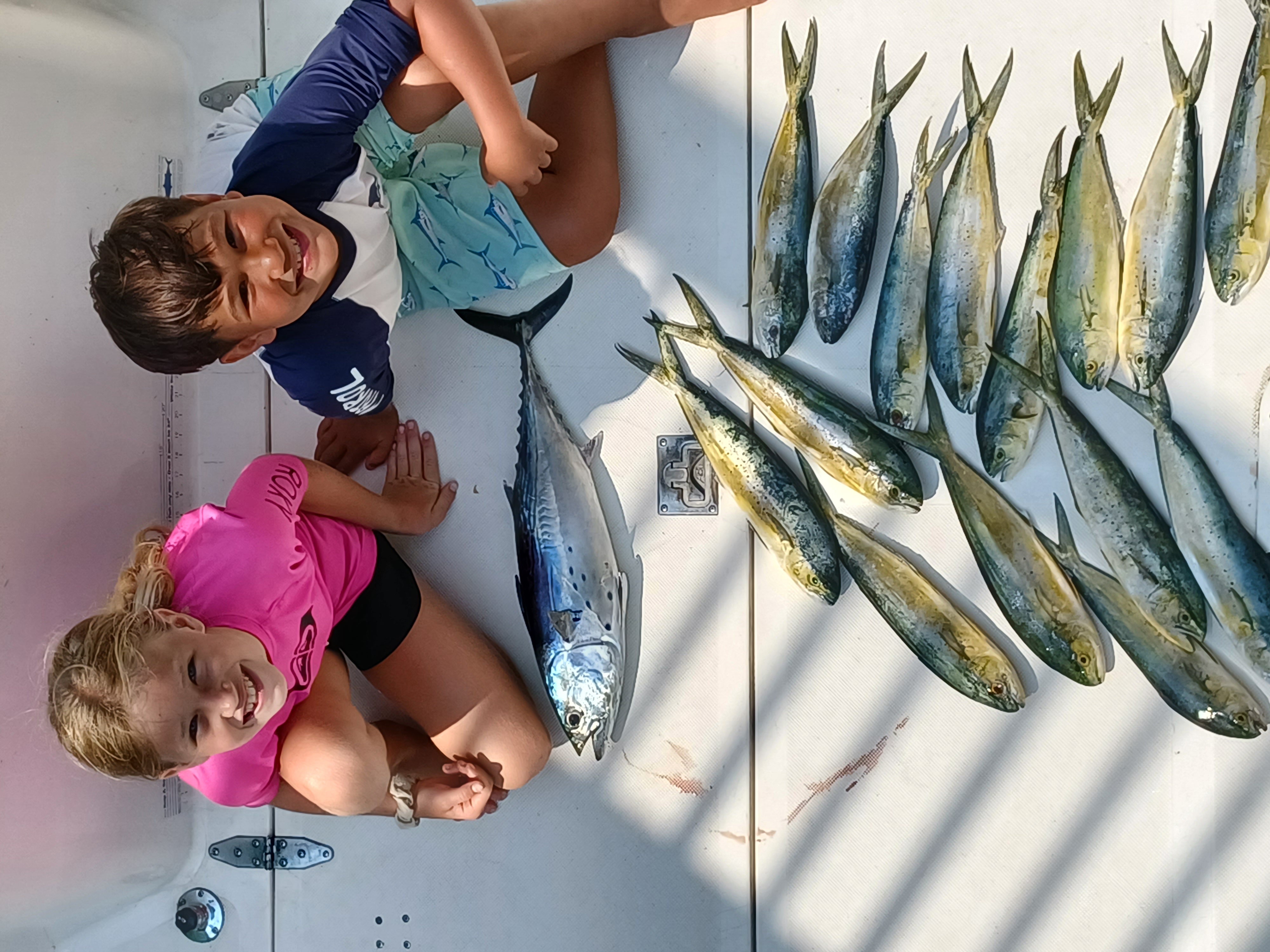 Successful fishing catch of Little Tunny and Mahi Mahi displayed on boat deck in Fort Walton Beach FL