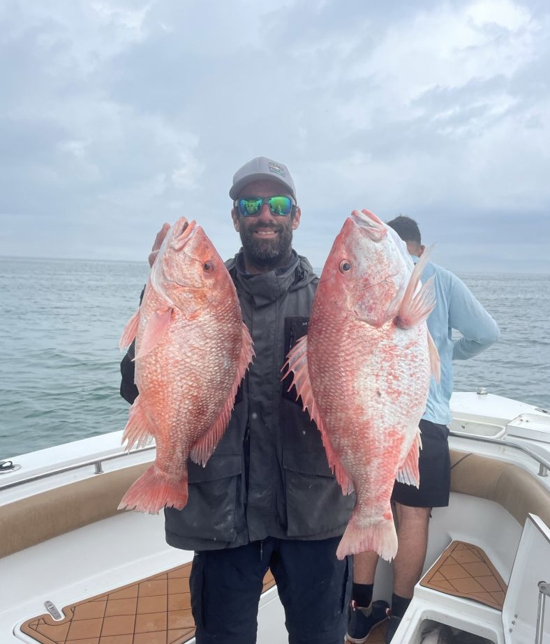 Angler holding two big fish in Galveston