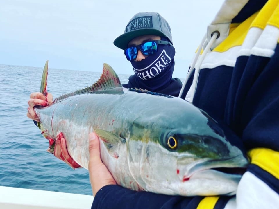 Fisherman holding a 23-inch fish in San Diego