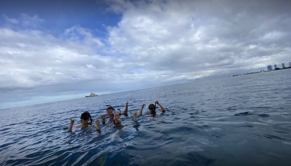 Three people enjoying a scenic outdoor adventure in Hawaii