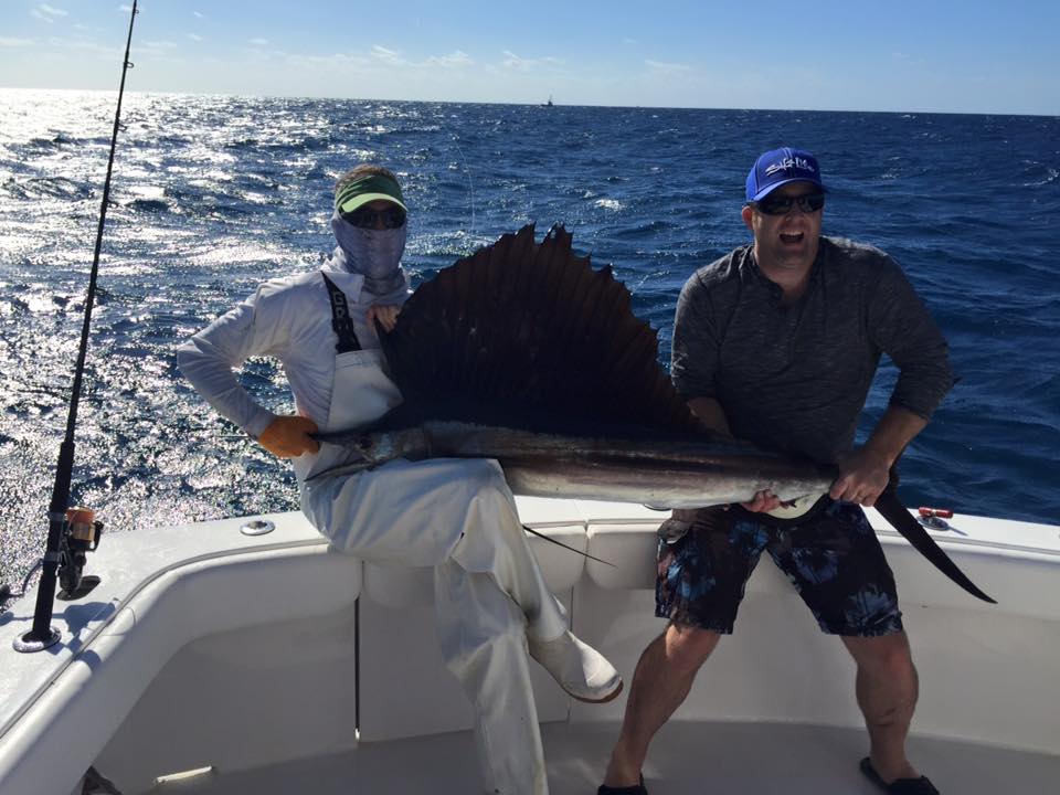 Angler with a large Atlantic Sailfish during a fishing trip in Florida
