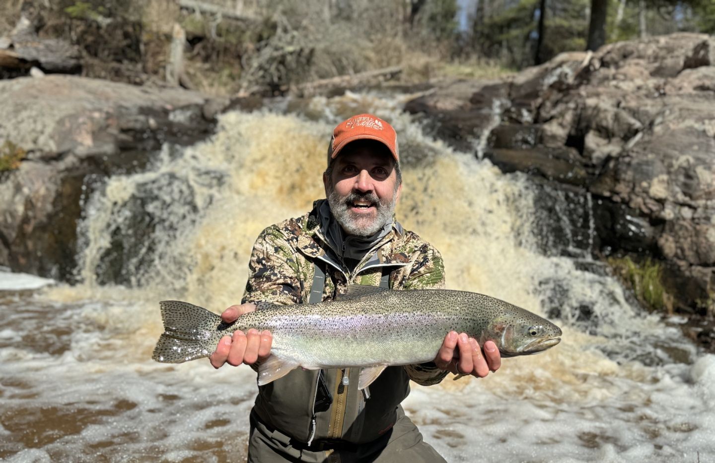 Angler fishing for a rainbow trout in Brule
