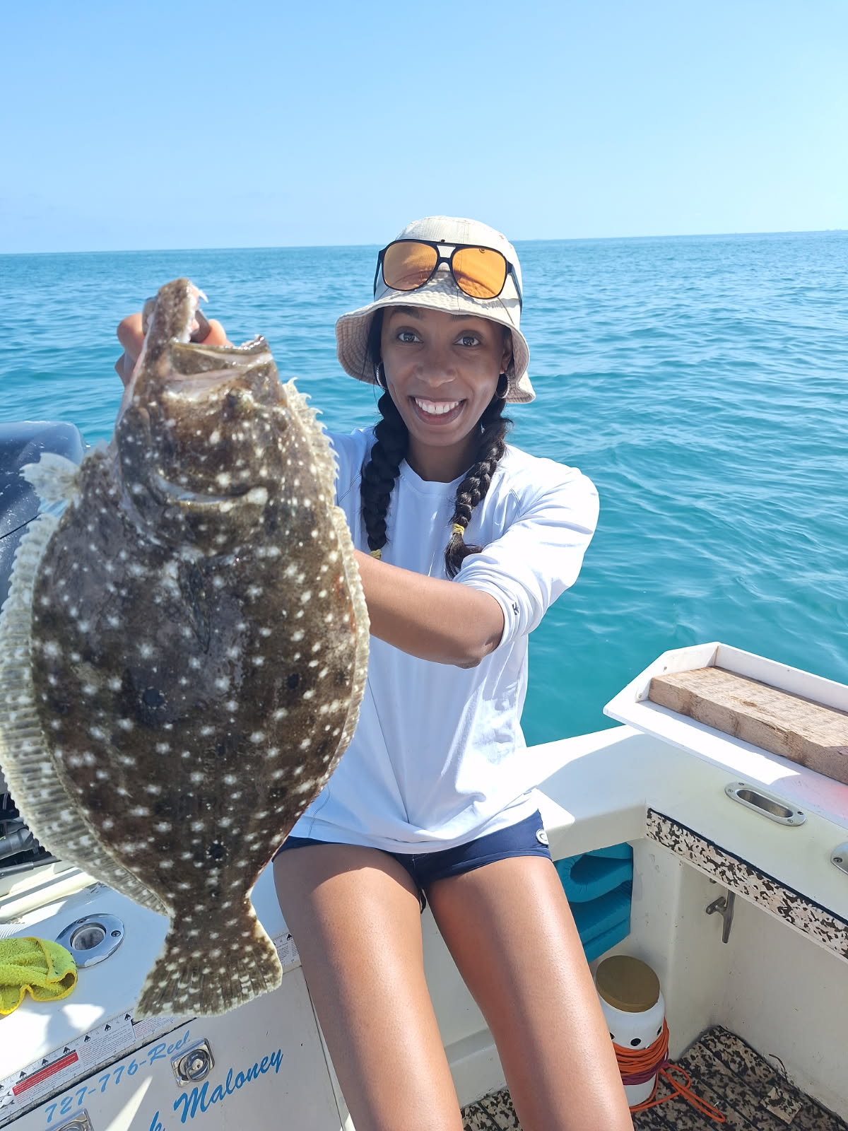 A fisherman reeling in a summer flounder in Florida