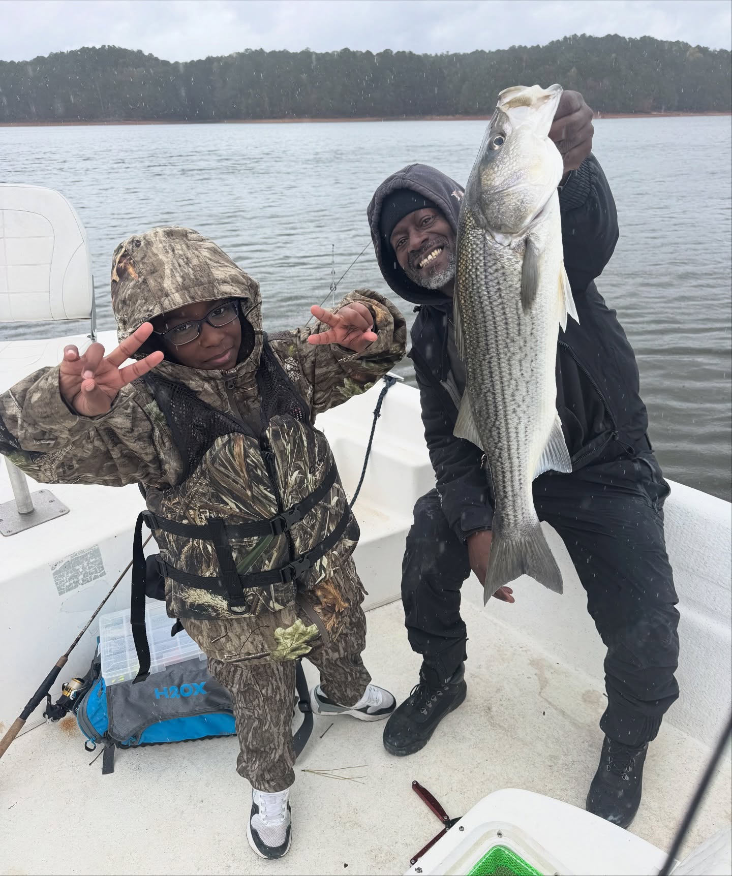 Three people fishing for a striped bass in Atlanta