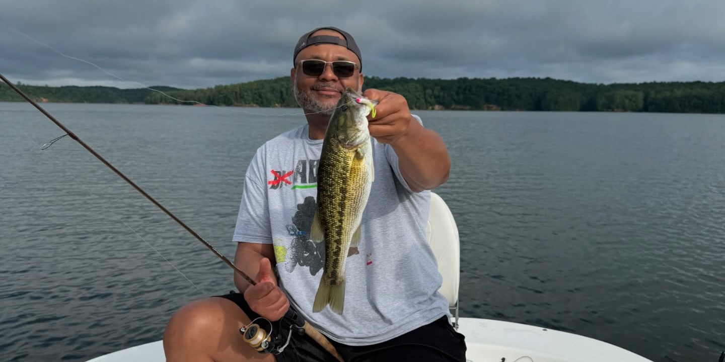 Angler fishing for hybrid striped bass on Lake Lanier with Captain Malik's guided morning trip