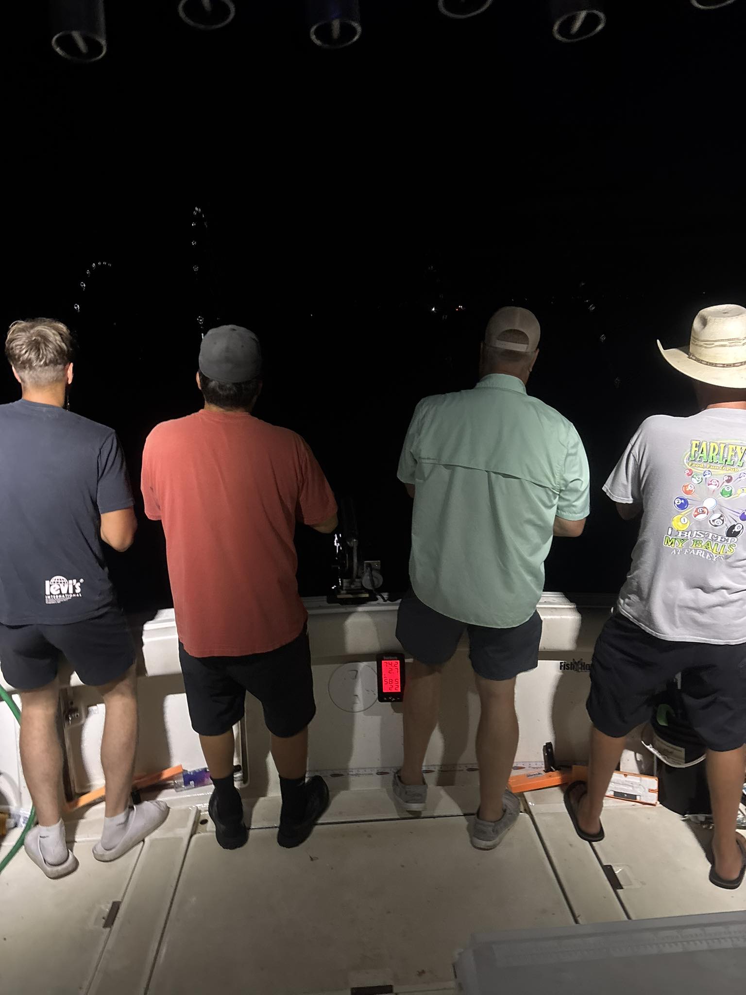 Night fishing on boat deck in Pentwater MI with fishing equipment and lights