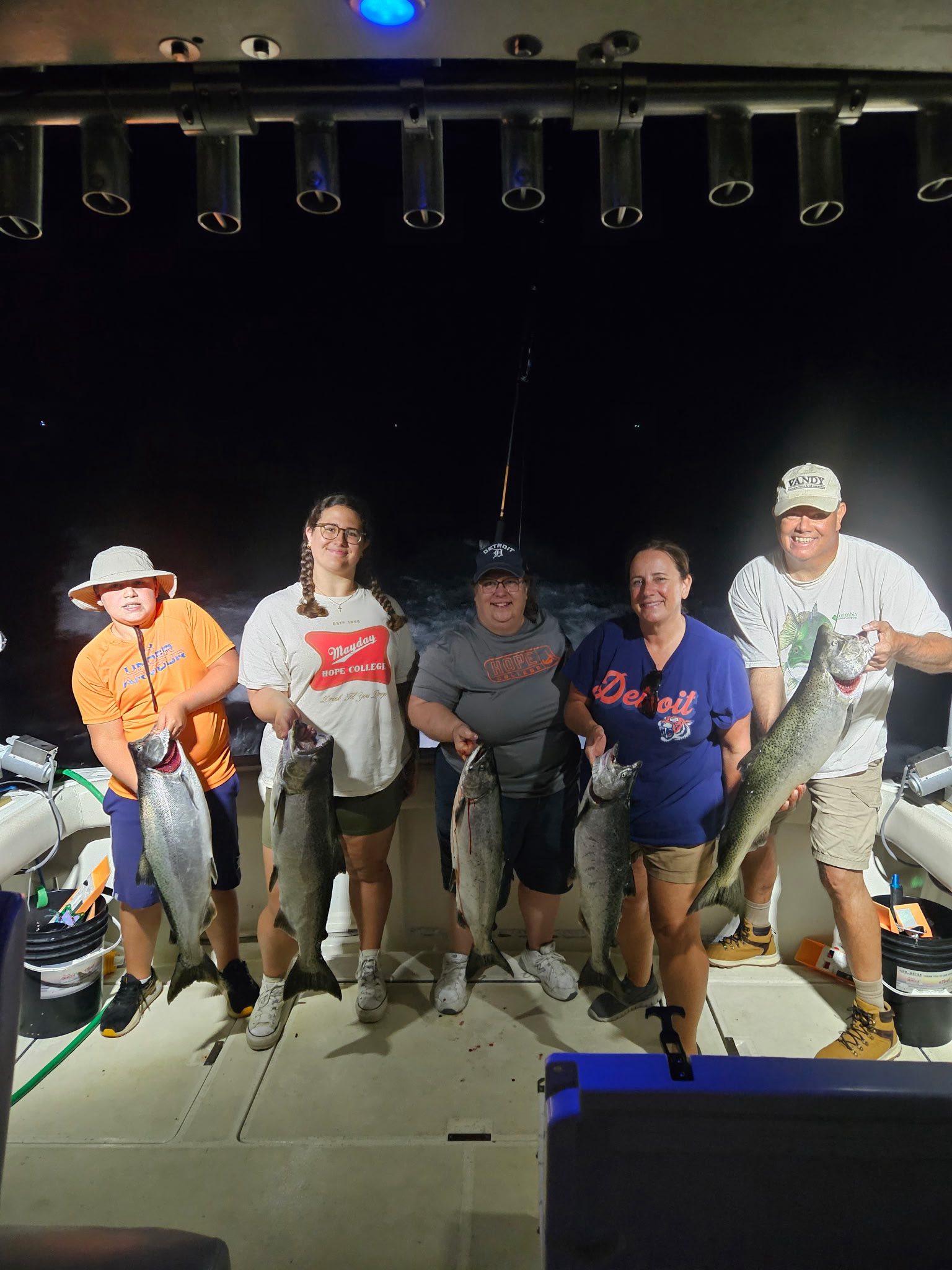 Successful fishing charter in Pentwater MI displaying Atlantic salmon, Chinook salmon, and Coho salmon catch