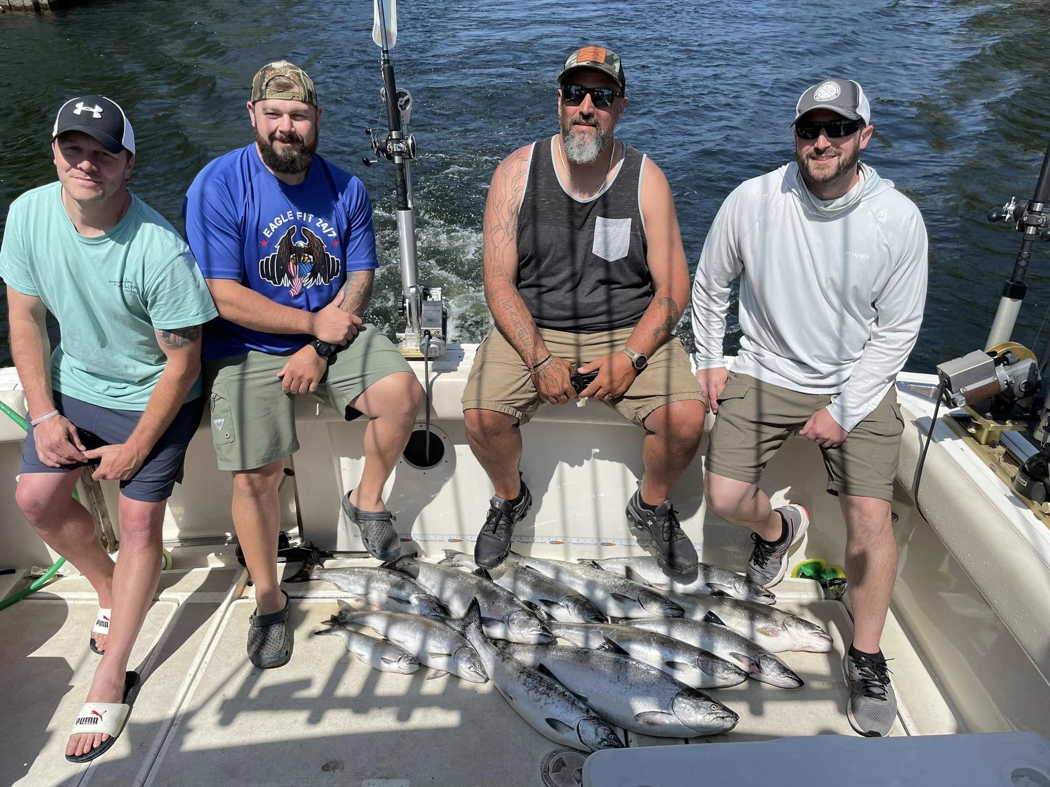 Lake Michigan salmon fishing charter boat with anglers trolling for King Salmon and Coho