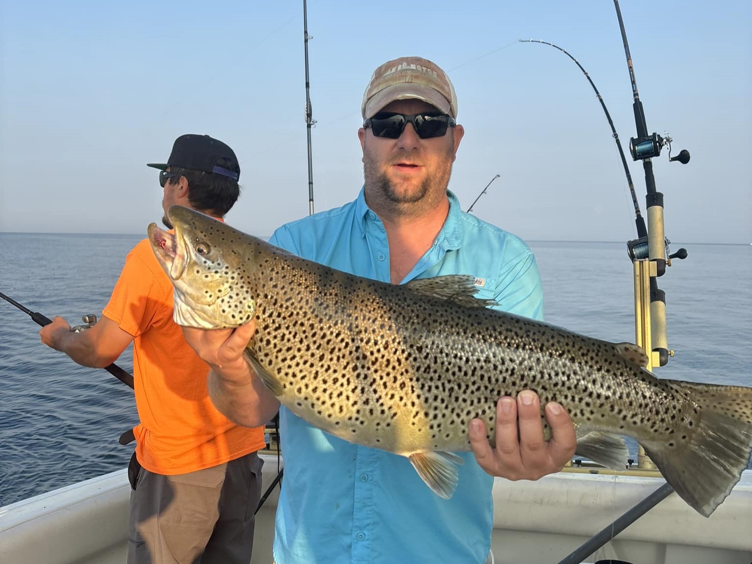 Lake Michigan fishing charter boat with anglers trolling for salmon and trout during tournament prep
