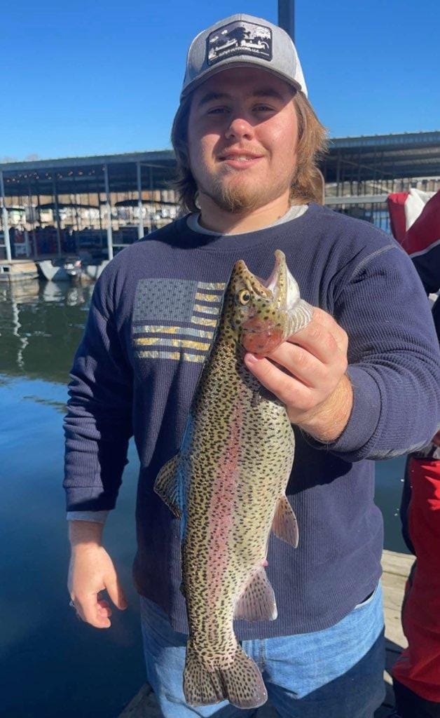 Angler holding a magnificent rainbow trout caught in Branson