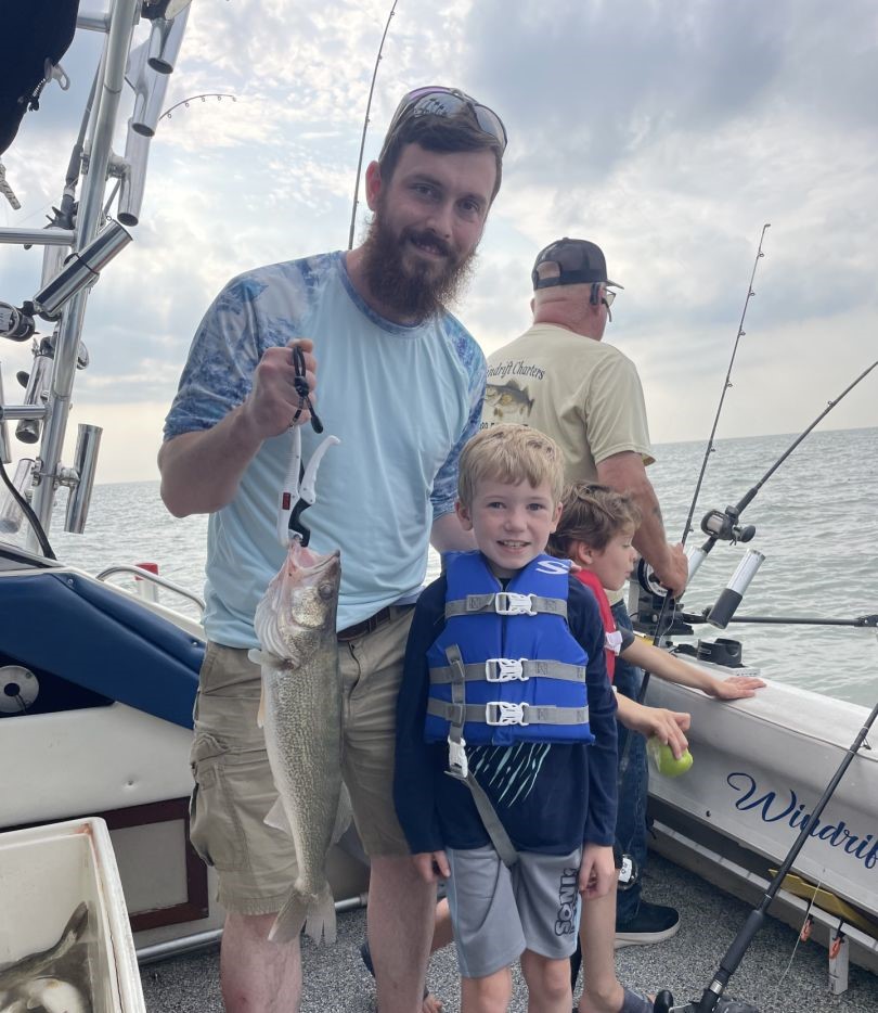 Walleye fishing success on boat in Linwood MI with freshly caught fish