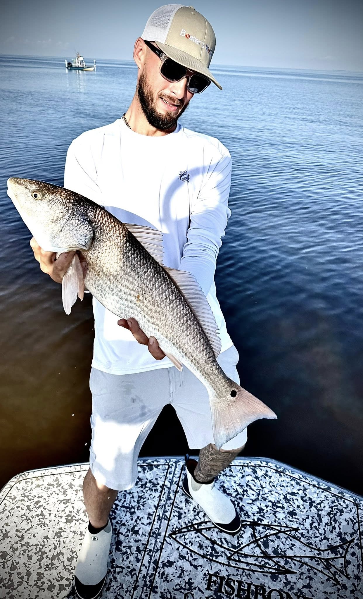 A fisherman with a redfish catch in FL