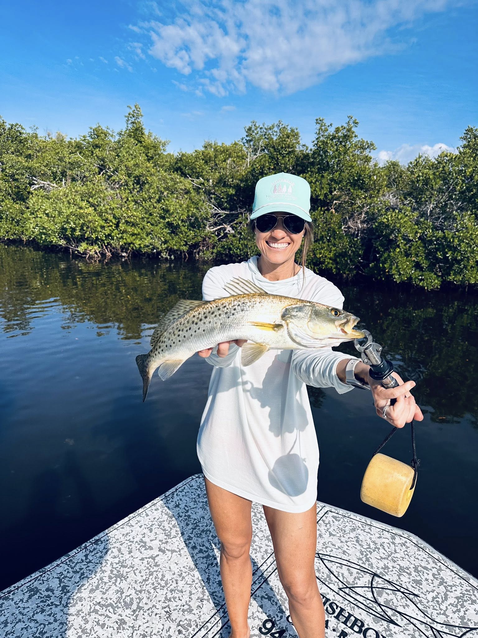 Angler catching a Spotted Weakfish in FL