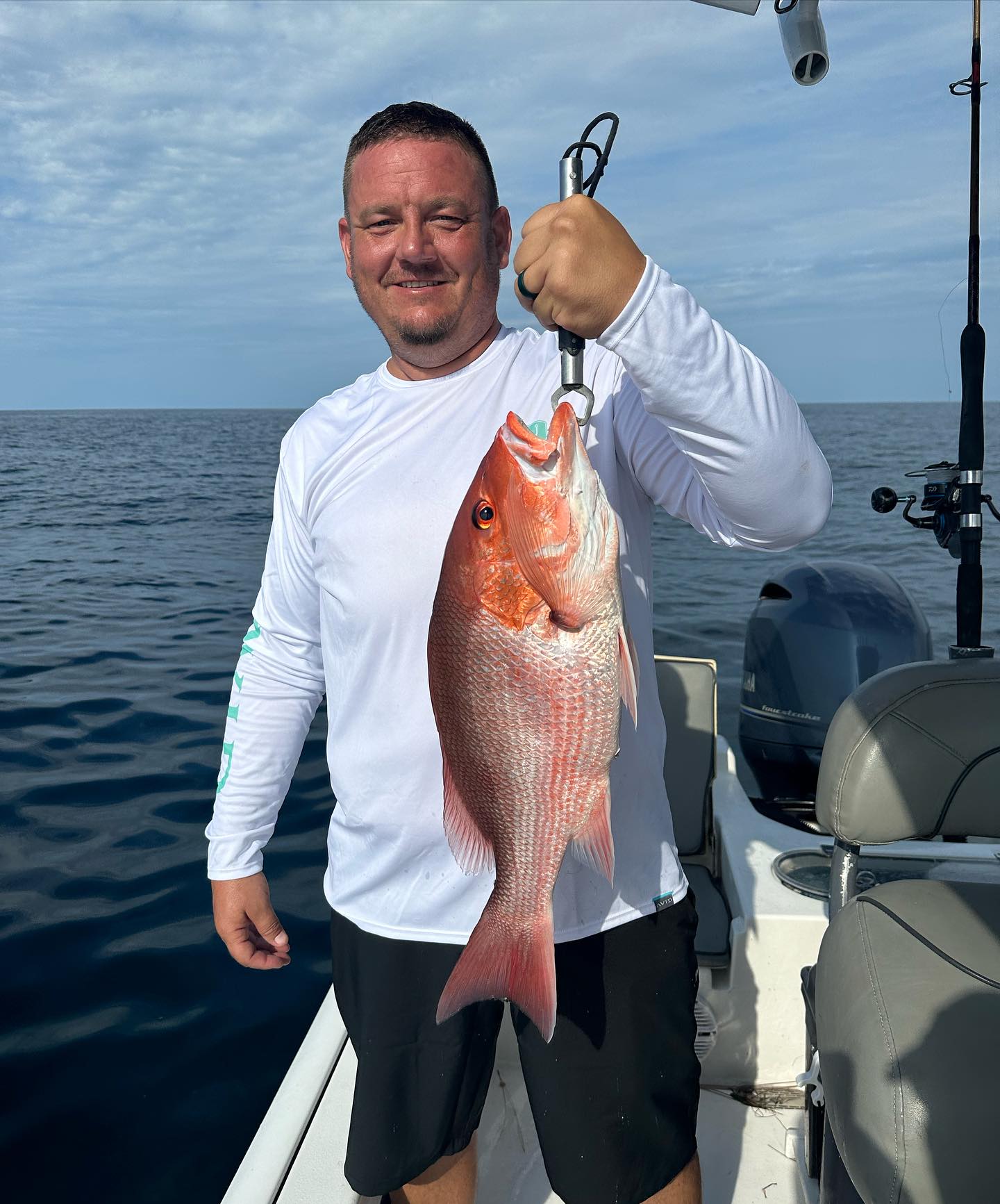 A grey snapper fish caught by a person at Panama City Beach