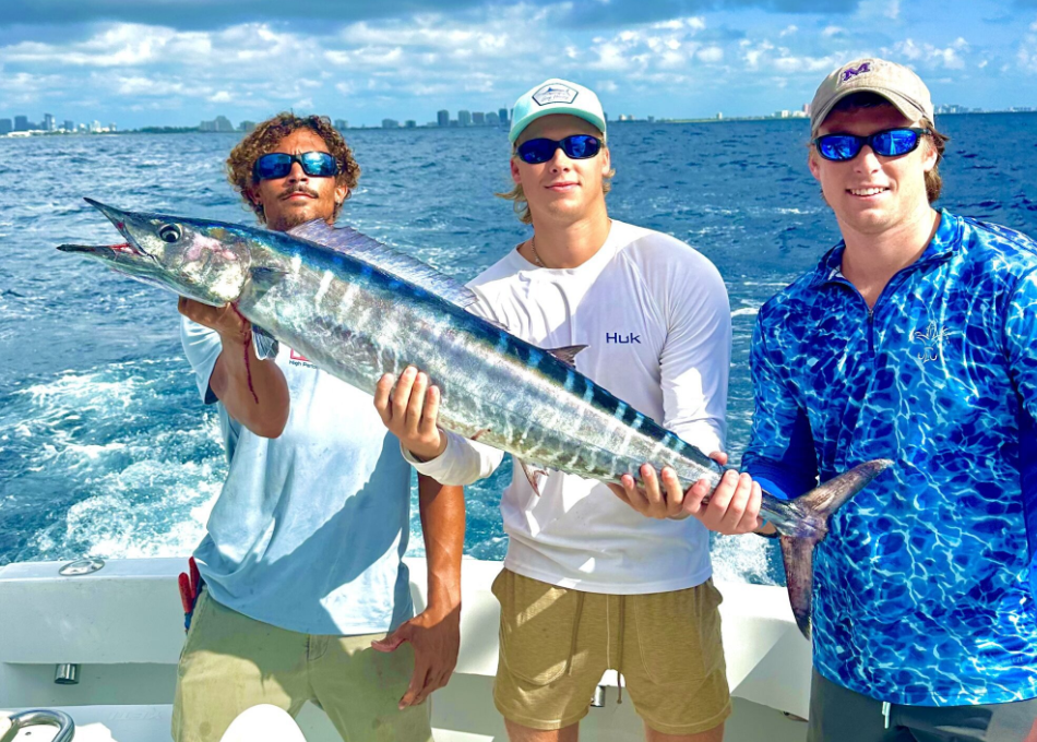 Three anglers with a 35-inch fish caught in Fort Lauderdale