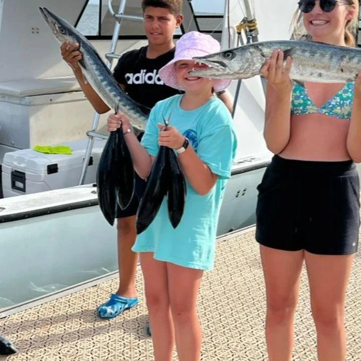 Great barracuda fishing catch displayed on boat dock in Cayman Islands