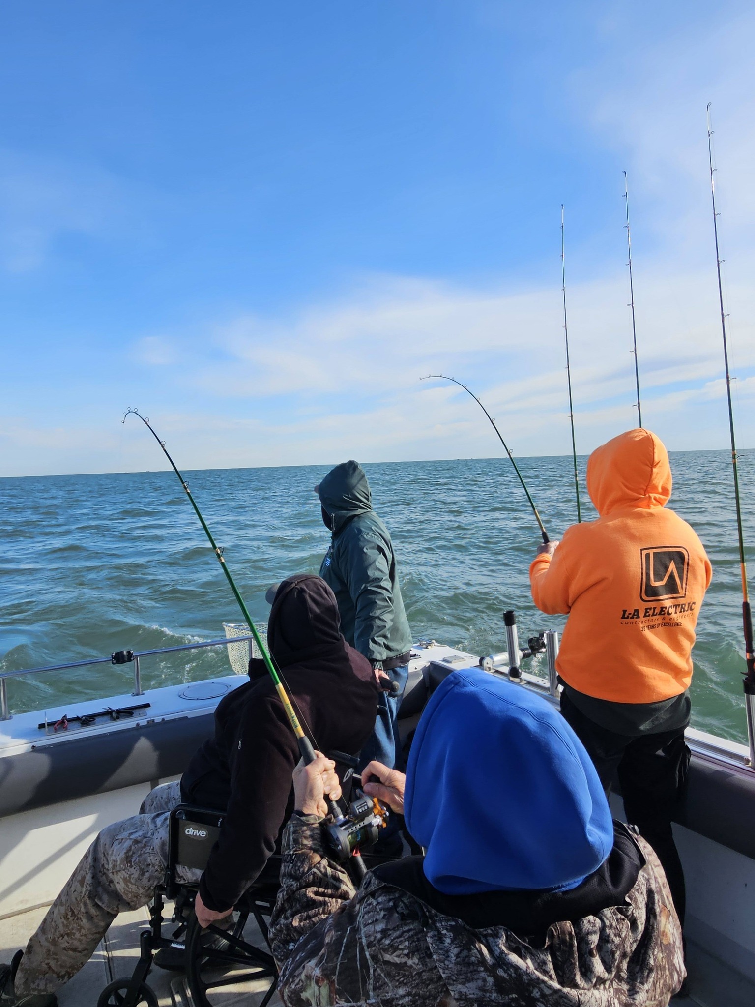Fishing rods bent with fish on the line during charter boat fishing trip in Port Clinton Ohio
