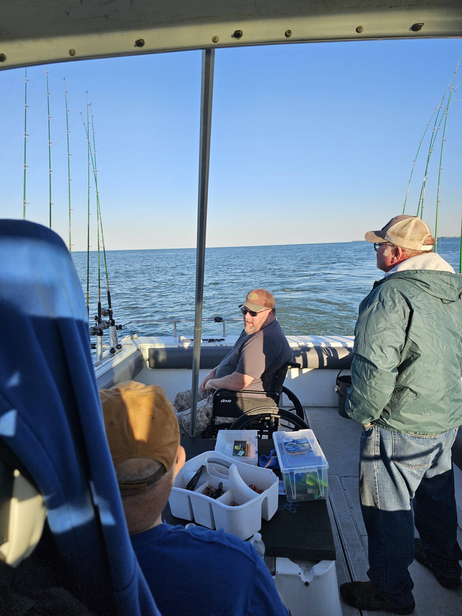 Fishing boat on open water in Port Clinton OH with multiple fishing rods set up for trolling