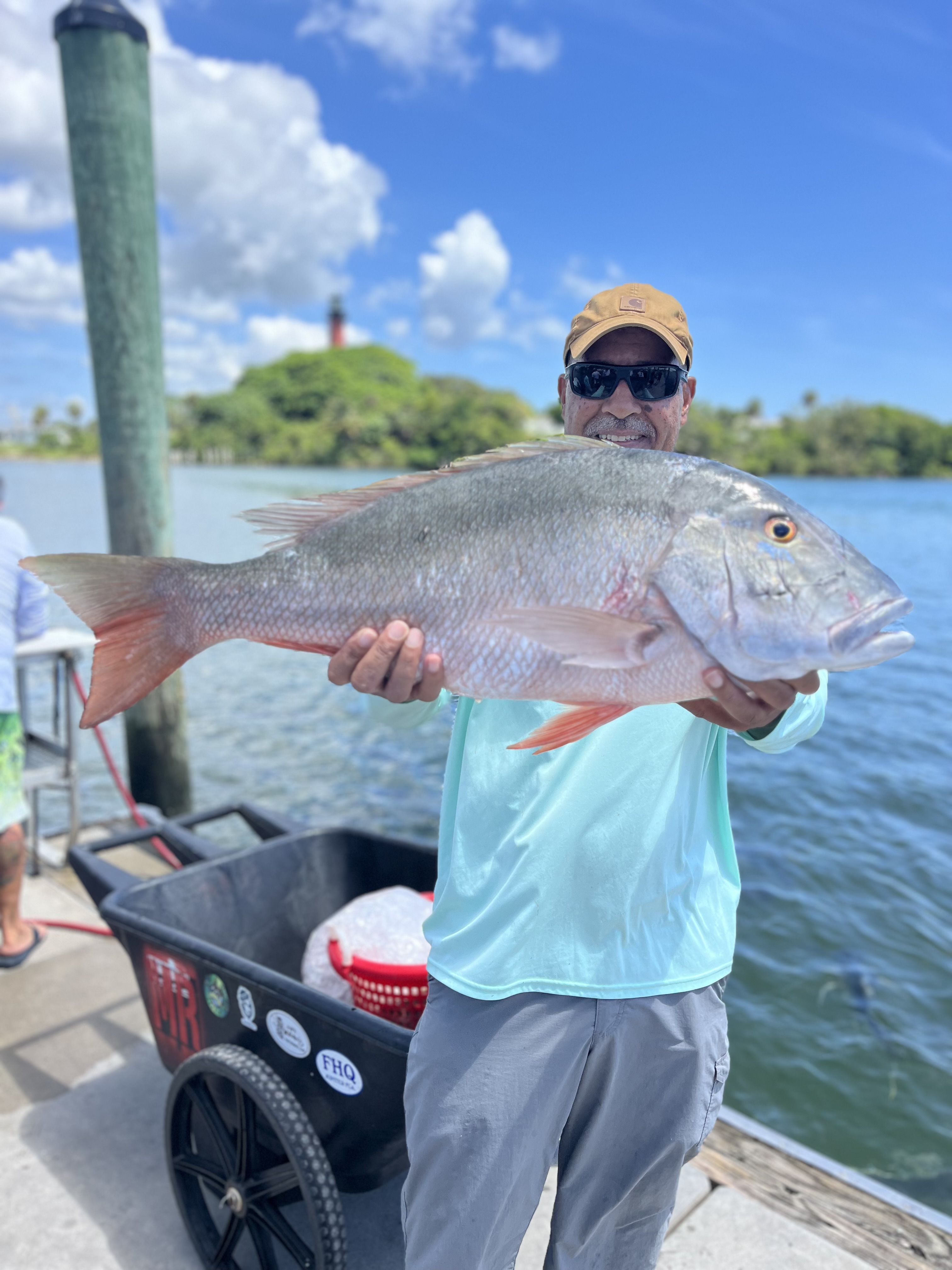 Fisherman catching a dog snapper in Jupiter