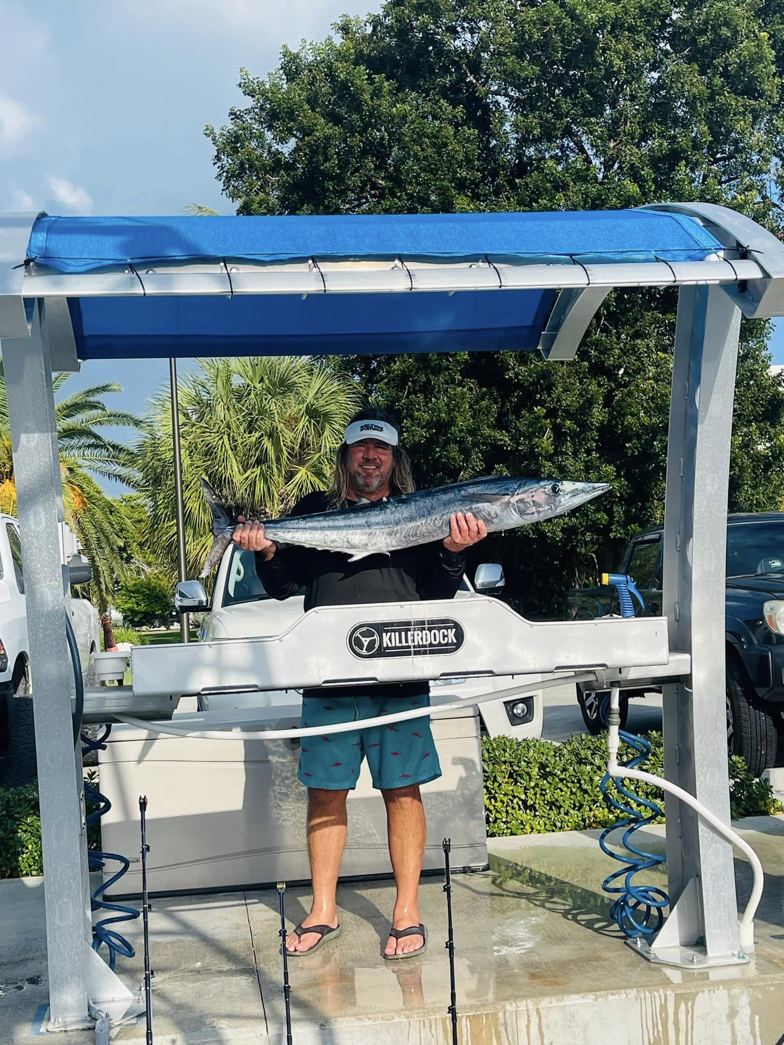 Angler posing with a large wahoo fish catch in Florida