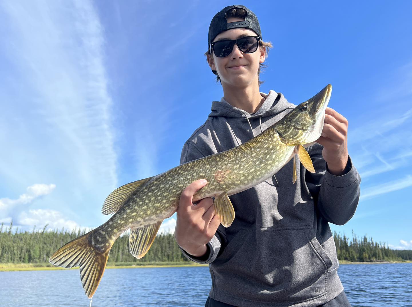 A Northern Pike fish caught by two people in SK