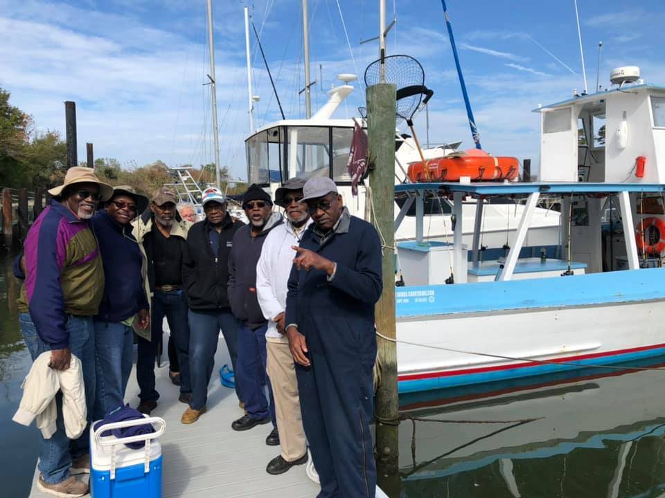 Eight people enjoying a day fishing outdoors in VA