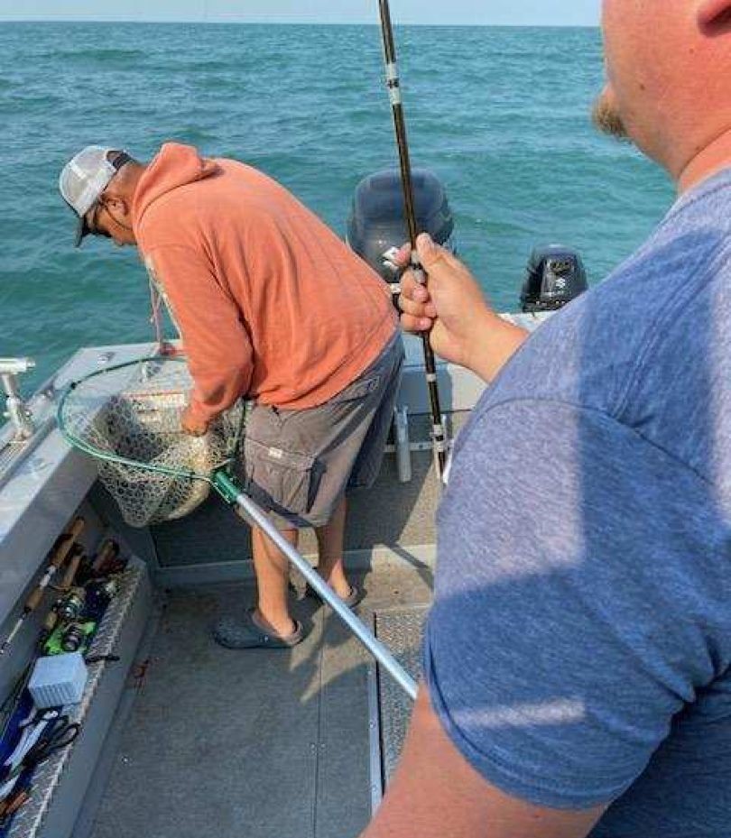 Fishing trip on Lake Erie near Marblehead OH with anglers working from boat deck