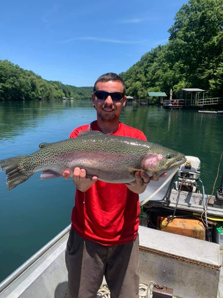 Angler with a large rainbow trout catch in AR