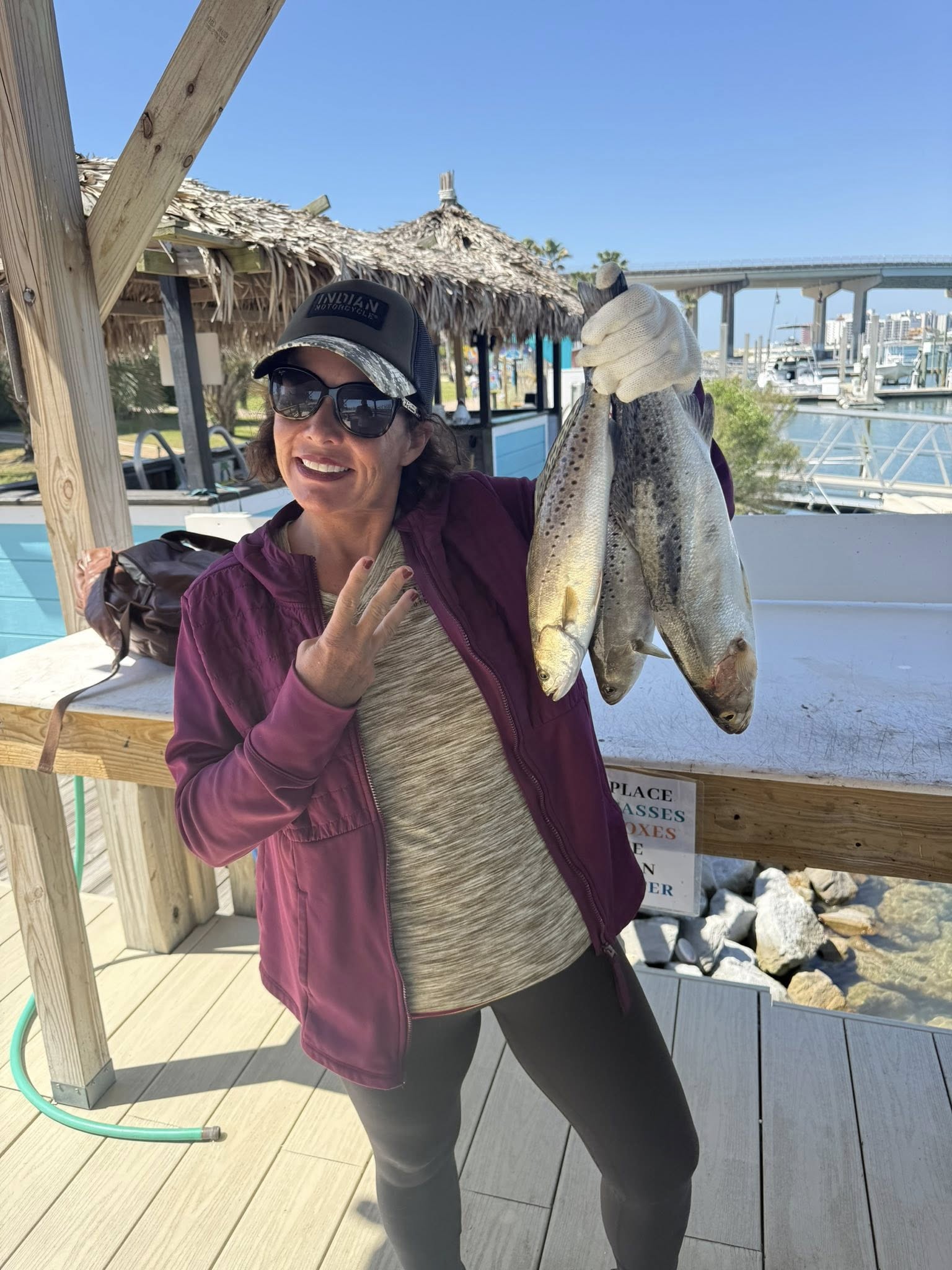 Two speckled trout caught fishing in Orange Beach Alabama displayed on wooden dock
