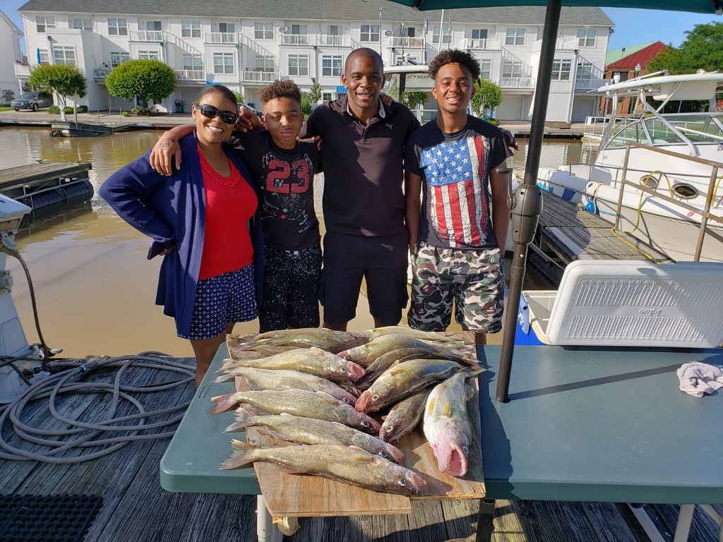 Four people enjoying fishing trip in Lorain