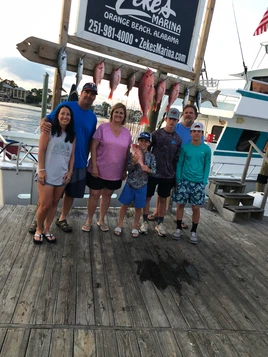 Group of 6 people fishing at Fort Morgan